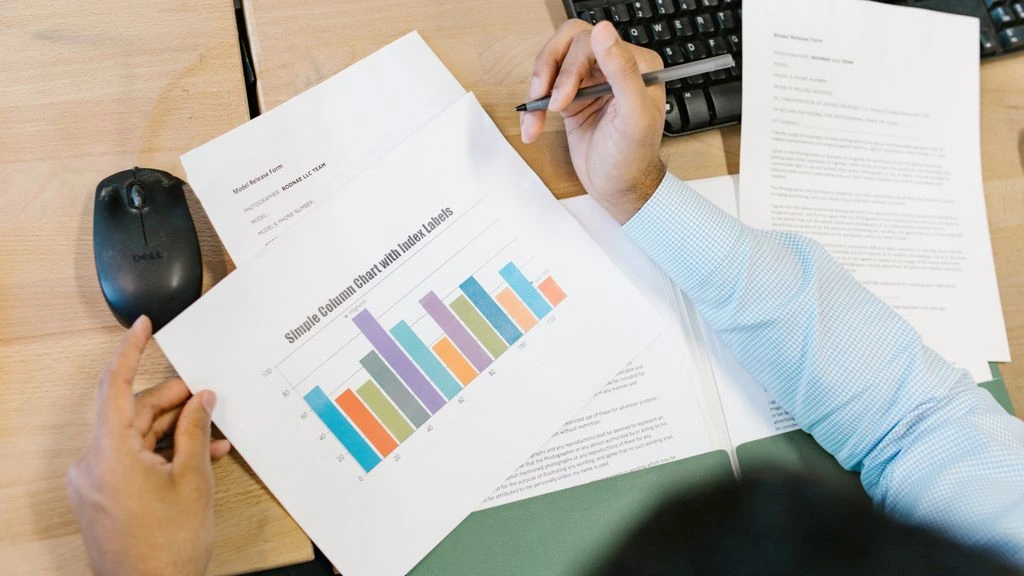 Analyst reviewing spreadsheets at a desk