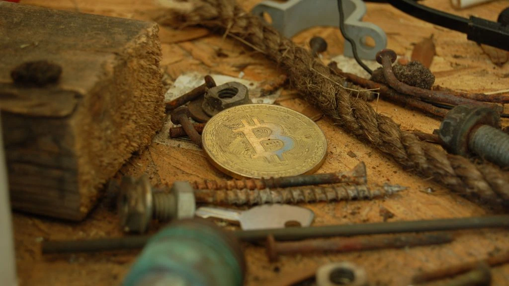 Hardware crypto wallet and notebook on a wooden table